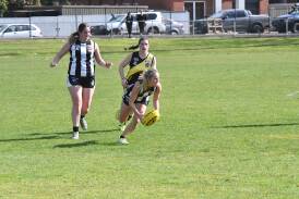 Castlemaine's Aisling Tupper pounces on a loose footy on the far wing of Canterbury Park. 