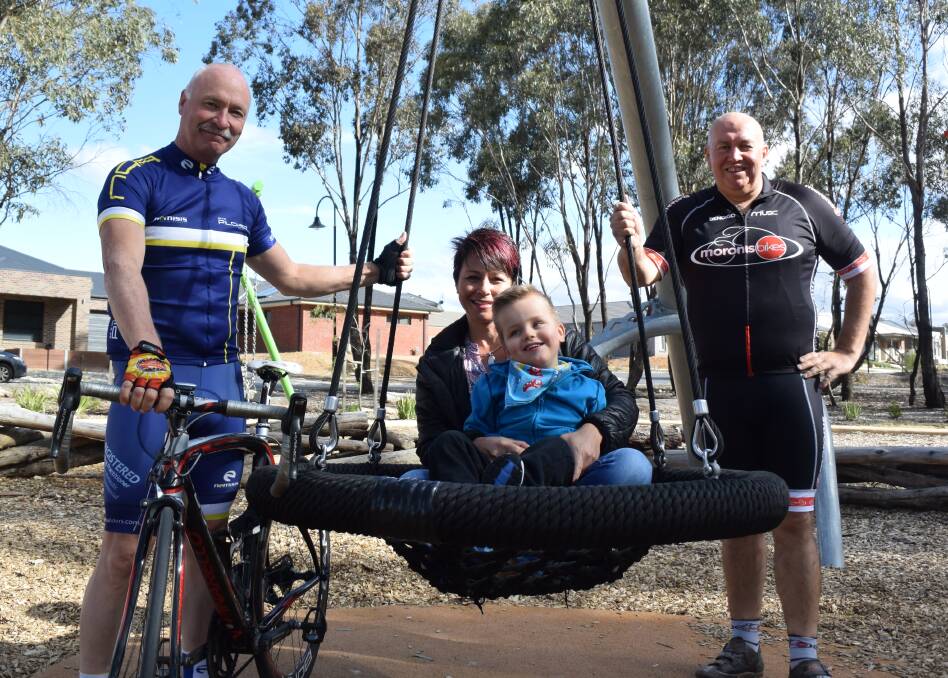 Graeme Pilcher and Andy Hoare with Natalie Watson and Hamish. The pair will cycle around Tasmania as a fundraiser for Very Special Kids. Picture: JASON WALLS
