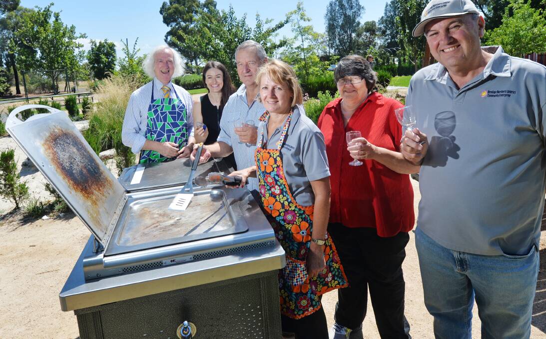 Cheers: Sandy Young, Leonie Francis, Mike Lowther and Barry Clay from the Bendigo Northern District Community Enterprise with mayor Rod Fyffe and Gemma Fennell at the Bendigo Botanic Gardens. Picture: DARREN HOWE