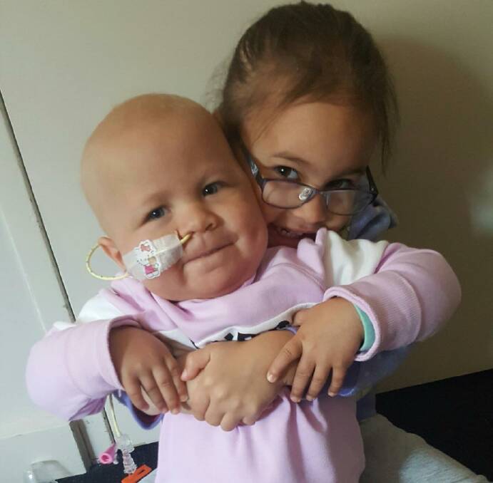 Fighter: Brydee Whiteman with older sister Allyrah after recovering from a bone marrow transplant in March. Picture: CONTRIBUTED