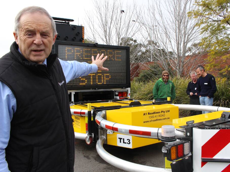 VicRoads regional director Mal Kersting explains the operation of a mobile attenuator. Picture: JASON WALLS