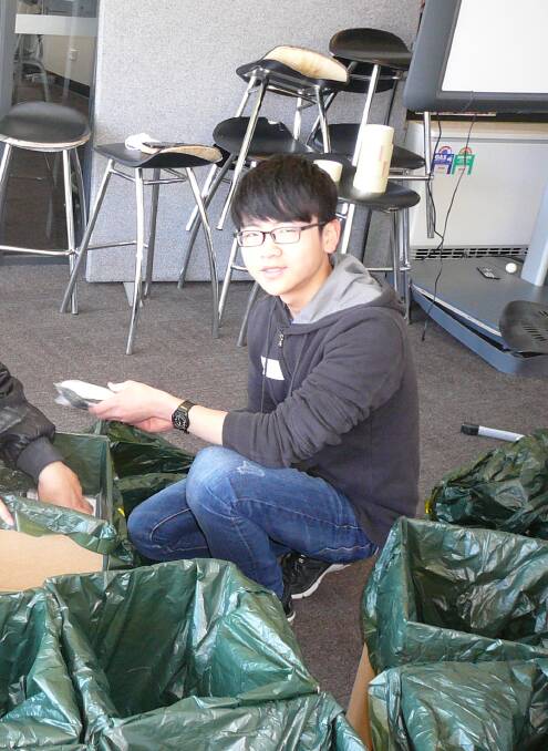 HELPING HAND: Renjie Qin puts together Zonta's birthing kits.