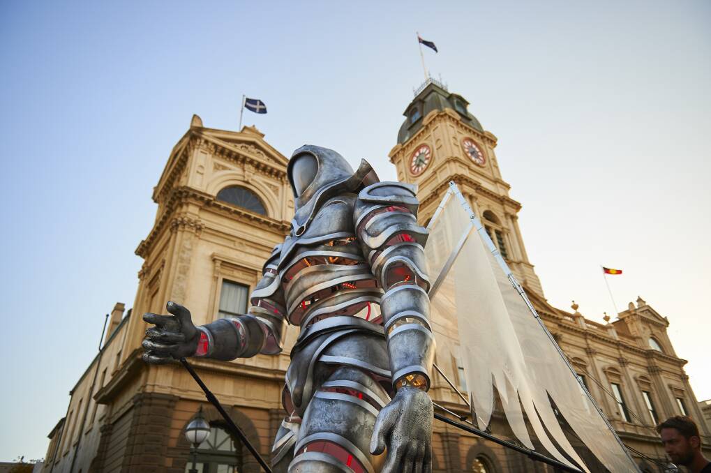 The White Knight Messenger strides past the Ballarat Town Hall during last weekend's festivities.