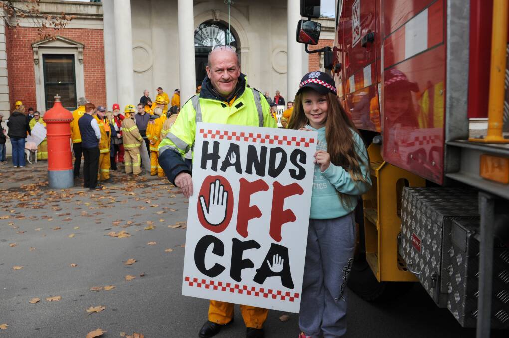 Castlemaine volunteer firefighter Bill Maltby and his niece Holly Button protest against the proposed EBA in June. Picture NONI HYETT