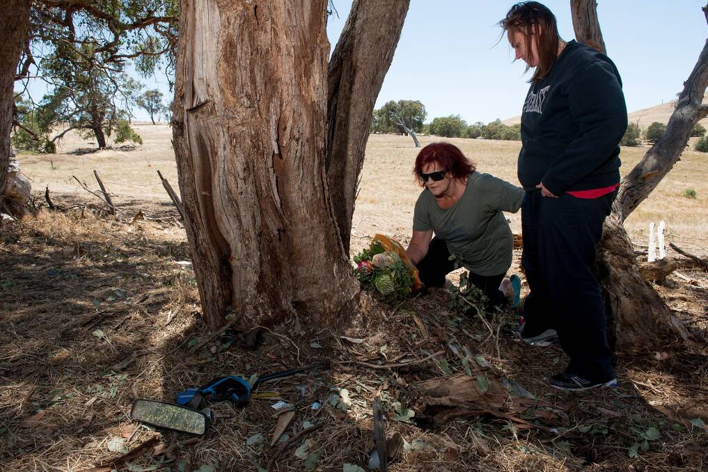 Nicholas Mongta's aunt Pamela Reade and cousin Tarah Reade leave a floral tribute at the scene of the crash in January 2015. Picture: JESSE MARLOW 