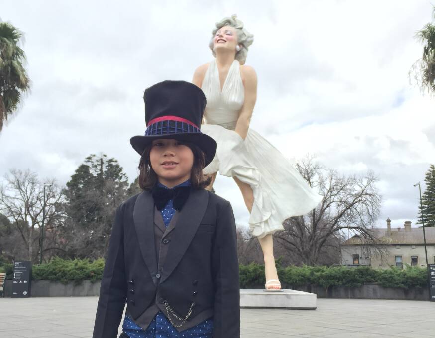 Melbourne seven-year-old William Nahm poses for one last snap with Marilyn before she is dismantled on Monday. Picture: JASON WALLS