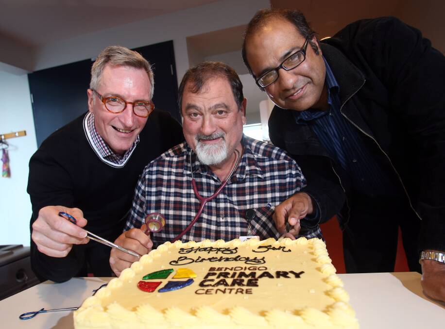 Doctors Dennis O'Connor, Ray Moore and Sajjad Muhammad cut the cake at the Bendigo Primary Care Centre on Monday. Picture: GLENN DANIELS