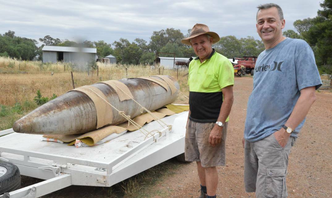 VERY RARE: Aviation researcher and historian Grant Coles (right) travelled to Parkes on Thursday to collect the rare World War II drop tank that had been sitting on Stan Field's Back Yamma Road property for almost 70 years.