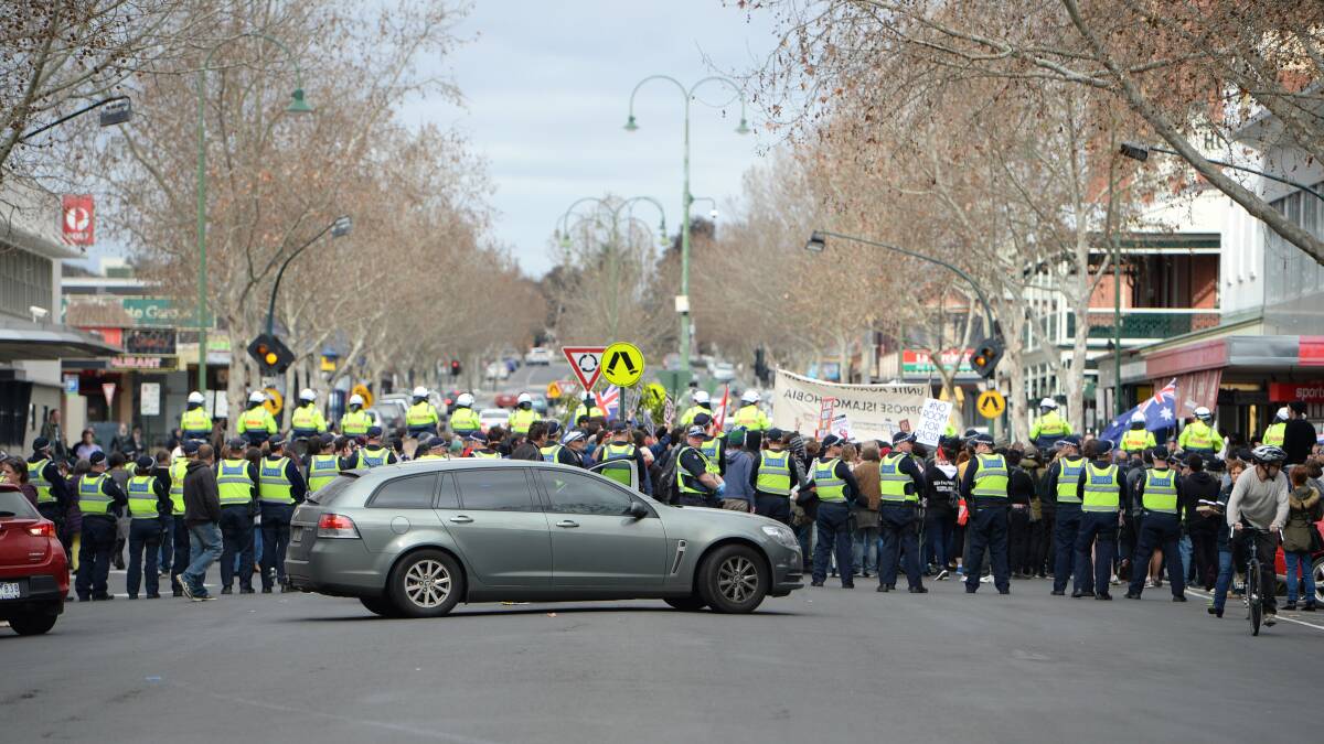 Police form a line across Williamson Street on Saturday afternoon, one of many in the precinct surrounding Town Hall. Picture: JODIE WIEGARD