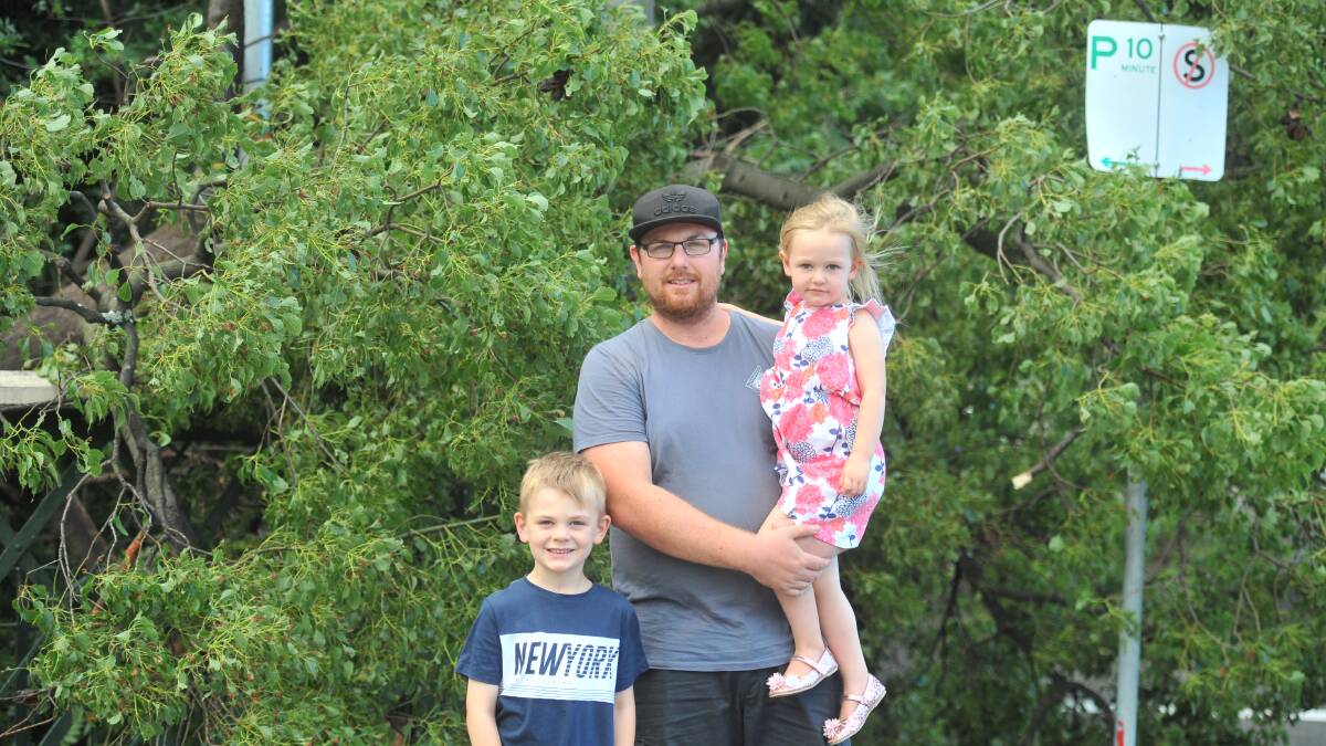 Wayne Bevans, with his children Aiden and Layla, had just parked near Rosalind Park when they saw a tree come down just metres away. Picture: Luke West