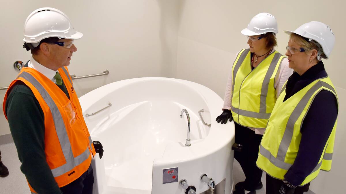 Bob Cameron and Fiona Faulks, of Bendigo Health, with Maree Edwards in the hospital's new maternity ward in 2016. The sector is being examined in detail by a parliamentary inquiry, with a range of issues becoming apparent.