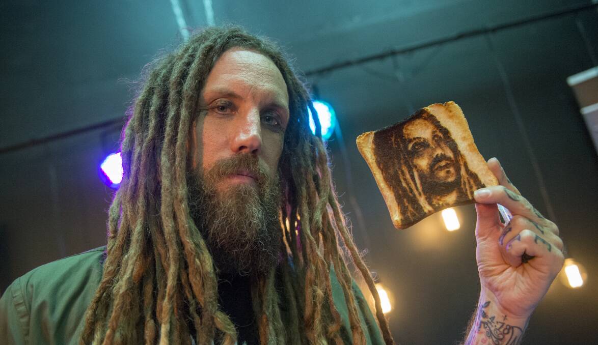 Brian 'Head' Welch, of nu metal band Korn, with a piece of memorabilia from a fan during a visit to Bendigo on Thursday. Picture: DARREN HOWE
