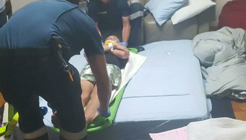 Corey Garner, 14, is loaded back onto a stretcher by paramedics in his lounge room after specialists in Melbourne ordered he be taken back to hospital on Saturday night.
