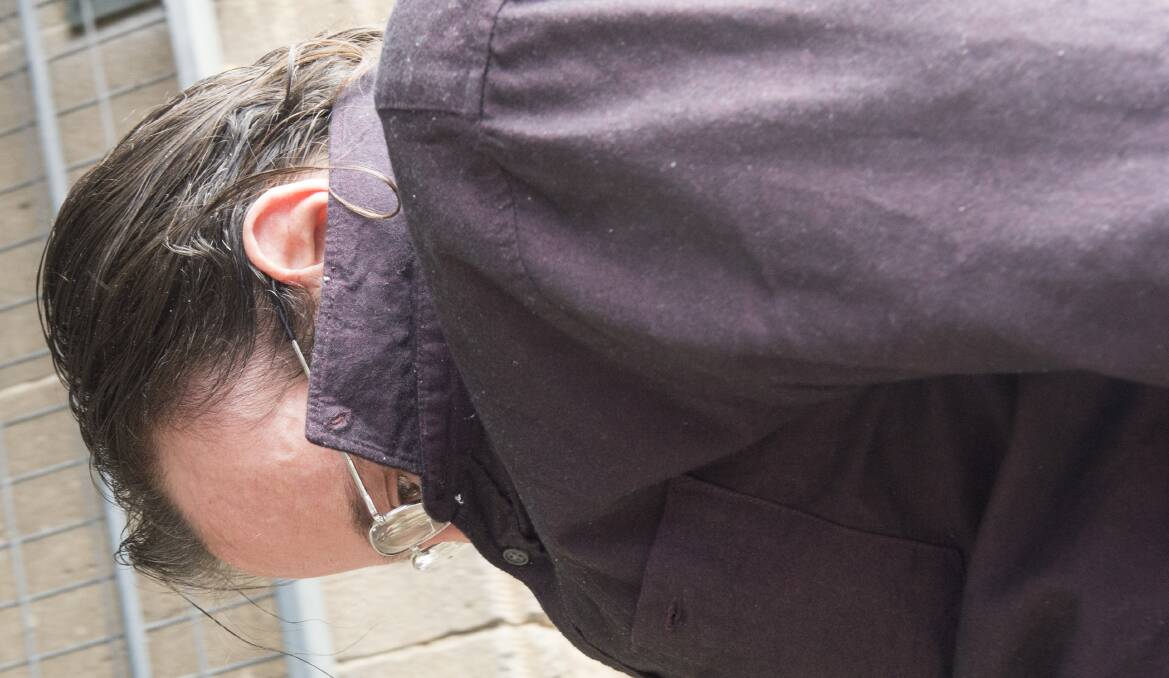 Gaunt uses his shirt to conceal his face as he enters court on Thursday. Picture: DARREN HOWE