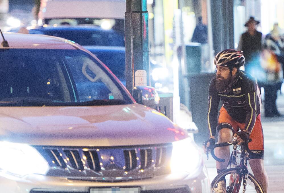 A cyclist attempts to negotiate the intersection of Queen and Mitchell streets on Thursday evening. Picture: DARREN HOWE
