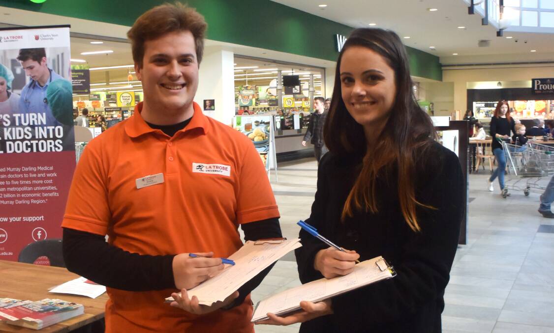 La Trobe University students Ryan Layton and Rachel Dodd collect signatures for a petition calling for the Murray Darling Medical School. Picture: Adam Holmes