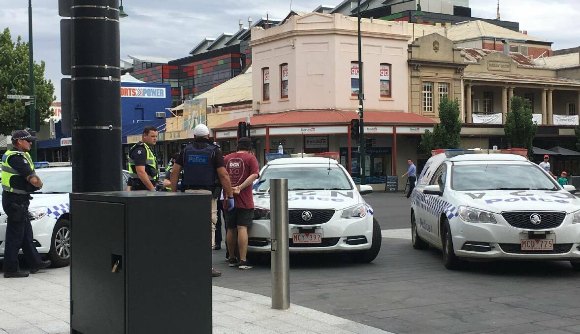 A second man is arrested in Hargreaves Mall. The first man - who allegedly spat at an officer - was earlier placed in the rear of a police car. Picture: ADAM HOLMES