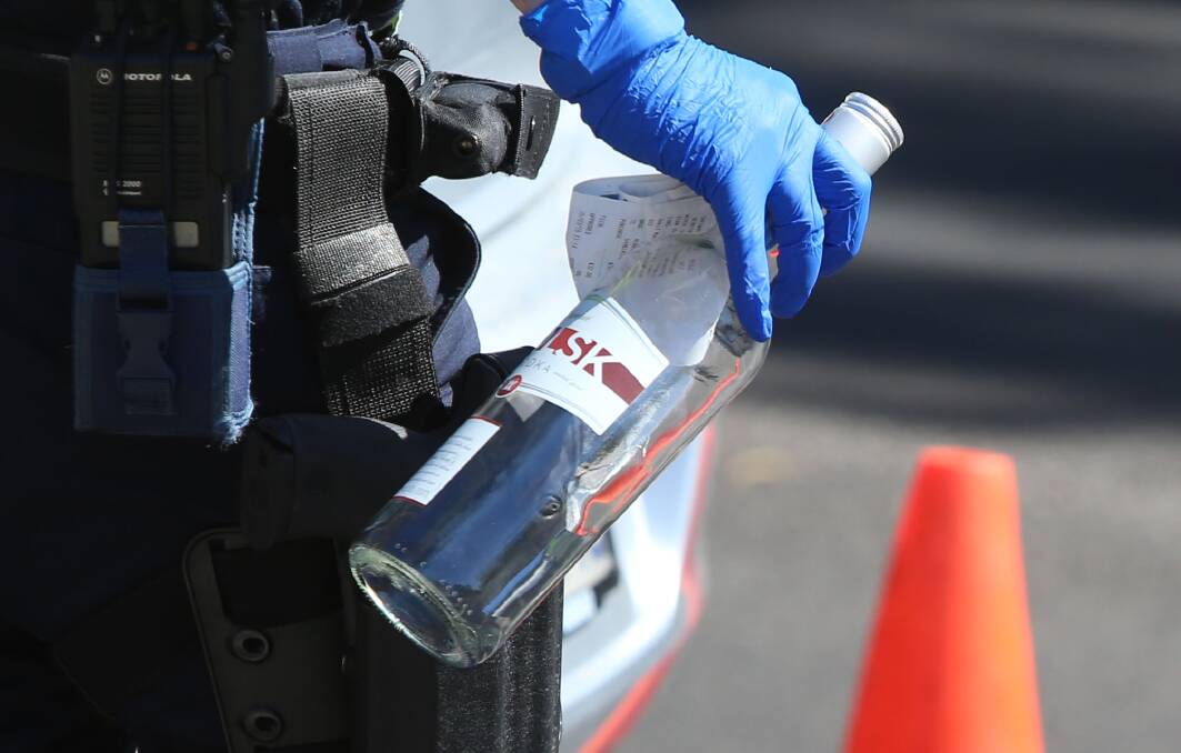 The empty bottle of vodka found in the car, along with a receipt showing it was purchased three hours before the crash. Picture: GLENN DANIELS