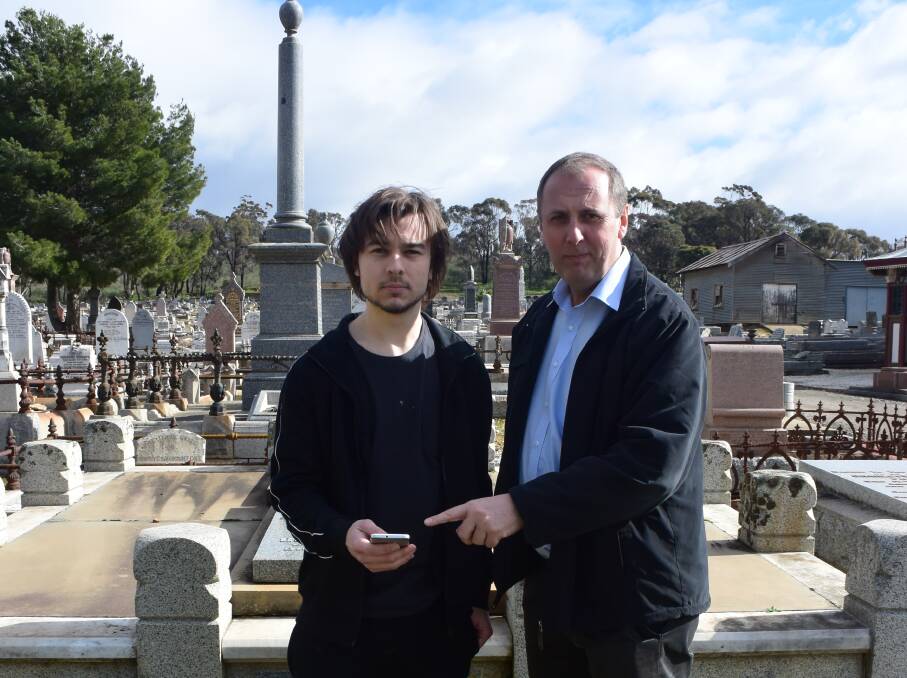 Pokémon Go player Matt Dole with Remembrance Parks Central Victoria CEO Graham Fountain. The Bendigo Cemetery has become a hot spot for players, and Mr Fountain hopes they treat the site with respect.