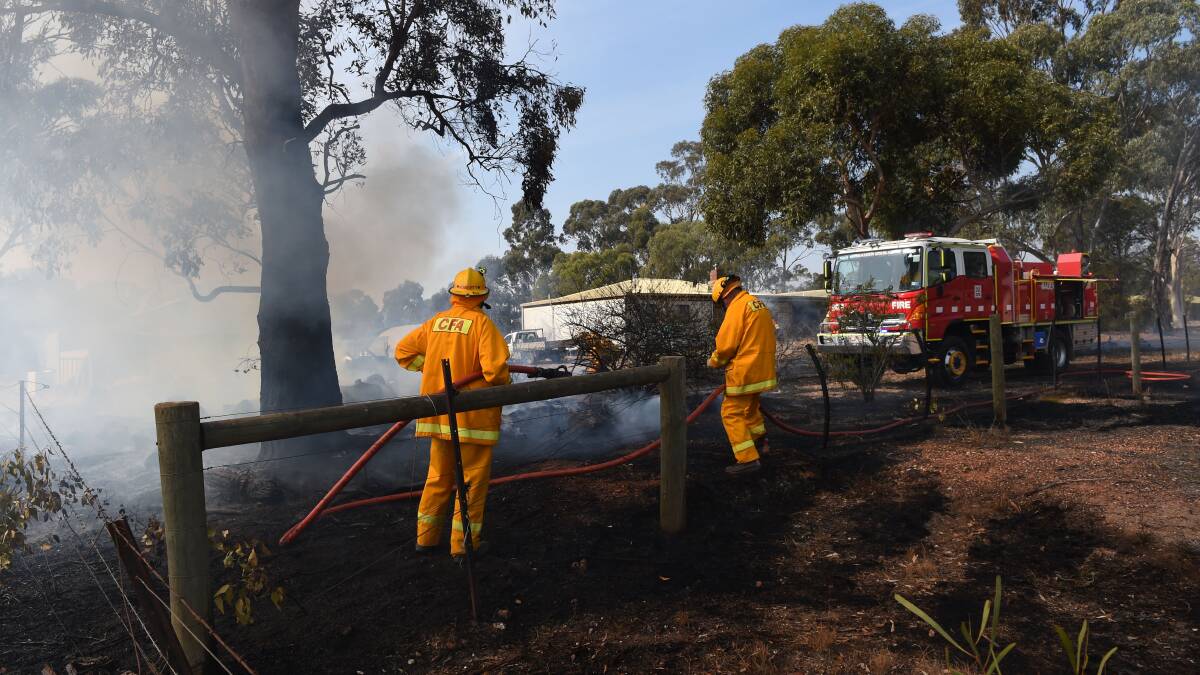 Members of the Maiden Gully Fire Brigade extinguish a fire on Patas Road in 2015.