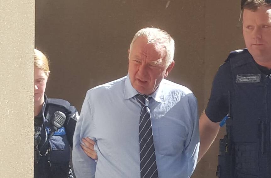 Ian Francis Jamieson is led away from the Bendigo court during his plea hearing on April 5. Picture: ADAM HOLMES