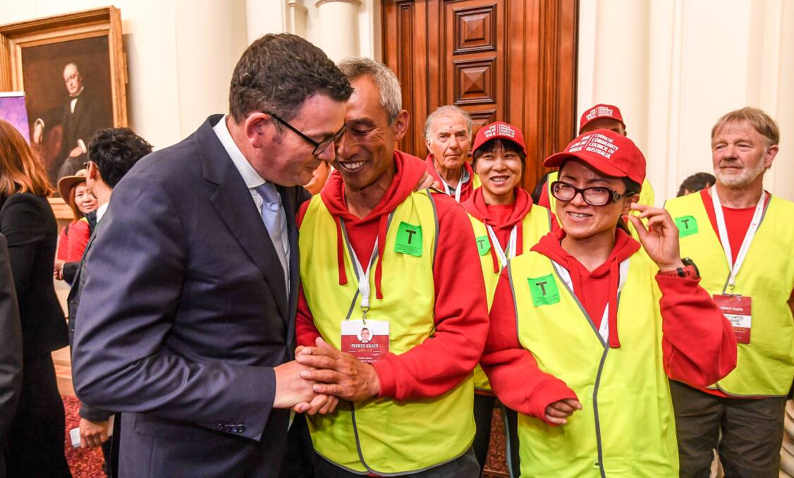 Premier Daniel Andrews with walkers who trekked from South Australia to Melbourne to highlight past injustices faced by the Chinese. Picture: Justin McManus