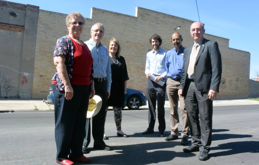 Cathie Steele and Dean Shirley, of Foodshare, with Pauline Gordon, Matt Kerlin, Mark Weragoda and James Williams from the council, in front of the former Crystal Ice building on Garsed Street.