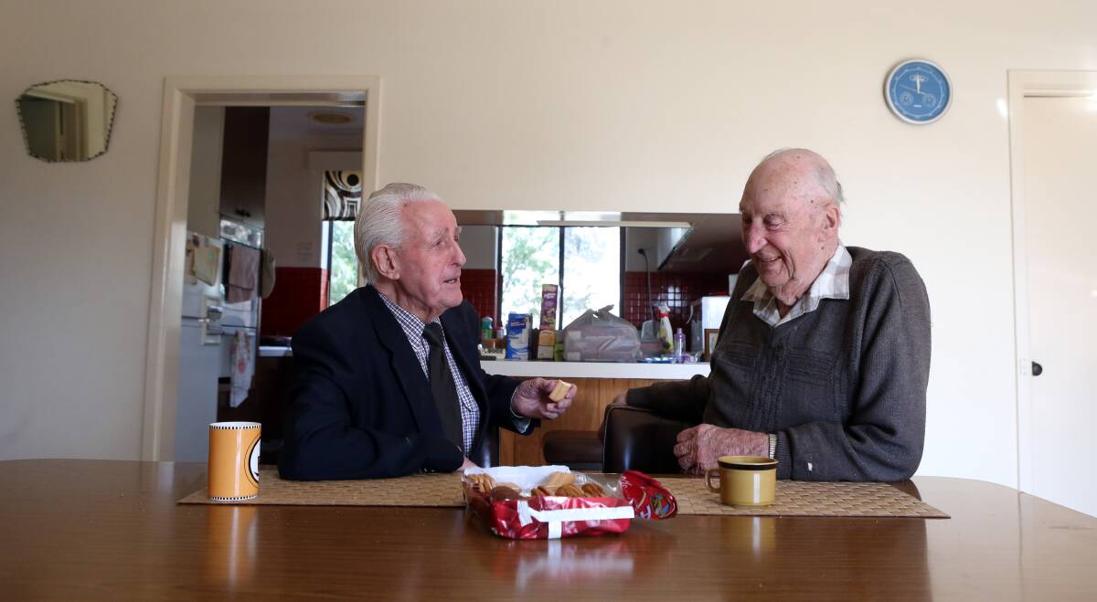 Former car salesman Alf Richardson and former Colbinabbin farmer Alan Brown chatting over a pack of biscuits, a tradition for more than 30 years. Picture: GLENN DANIELS