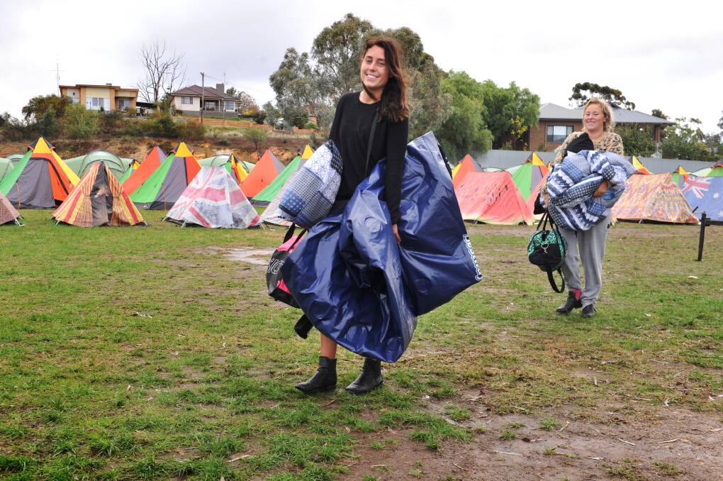 Jessica Turland-Rhook and Ailish McCorkell packed up their flooded and ripped tent and prepared to head home. Picture: NONI HYETT