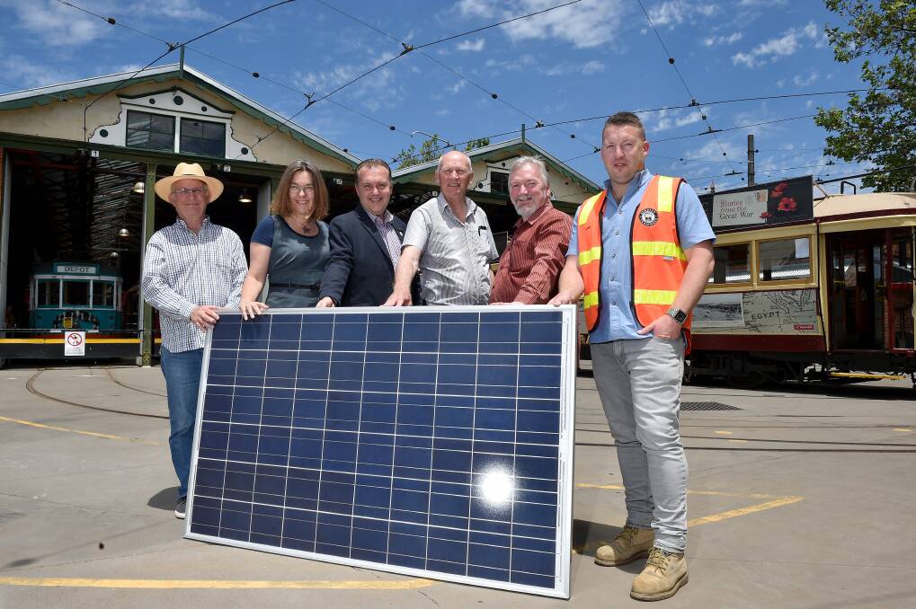 FUTURE POWERS PAST: Chris Weir, Ann Lansberry, Peter Abbott, Colin Lambie, Wayne Gregson and Luke Jenkins with a solar panel to be placed on the roof of the Bendigo Tramways Depot. Picture: NONI HYETT
