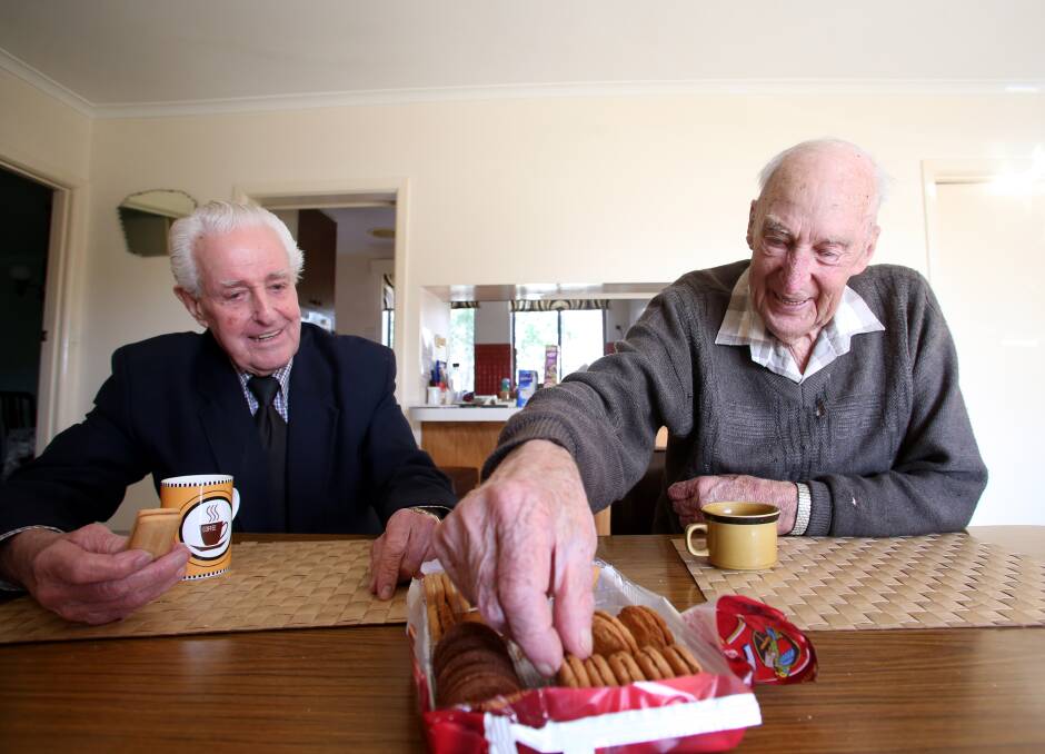 Former car salesman Alf Richardson and former Colbinabbin farmer Alan Brown chatting over a pack of biscuits, a tradition for more than 30 years. Picture: GLENN DANIELS