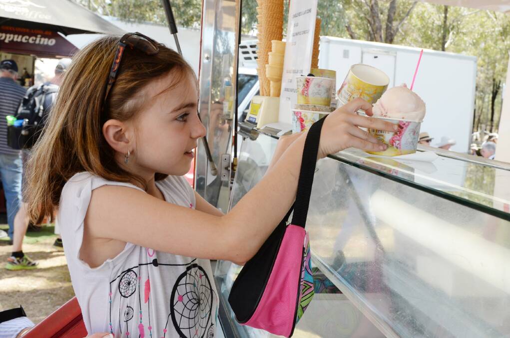 SWEET TREAT: Ella Ware buys a cup of gelati from Roberto Ocampo's food van. Ice cream was in demand during the warmer weather. Picture: DARREN HOWE
