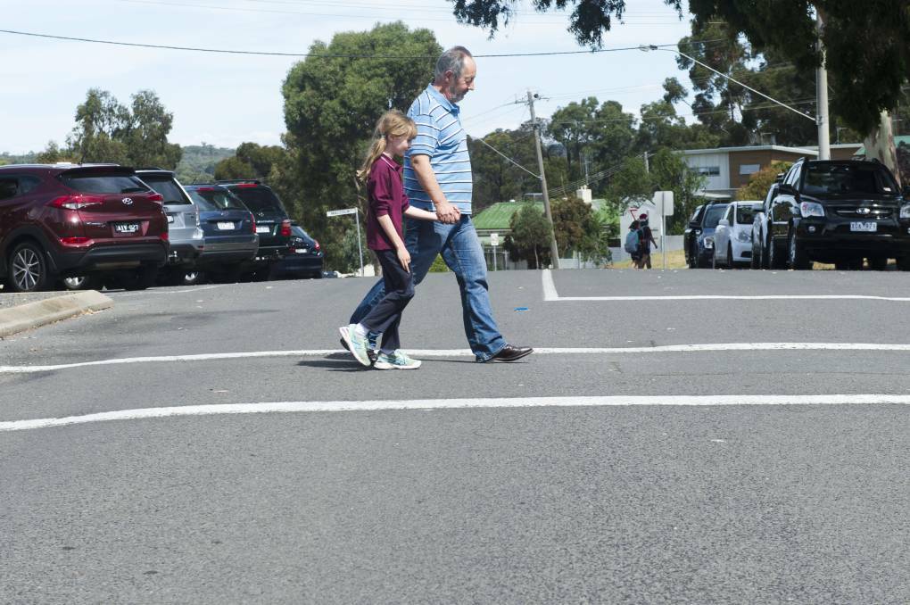 CONCERNED: Quarry Hill Primary School parent Tony Smith ensures his daughter Emma makes it safely across Peel Street. Picture: DARREN HOWE
