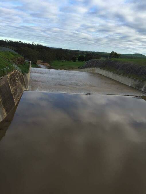 Tullaroop Reservoir started to spill on Friday - but gently. Picture: HELEN BROAD