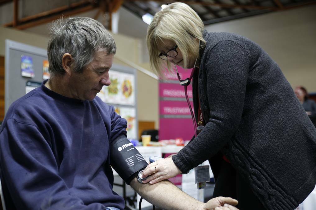 A Bendigo Health worker checks farmer Mark Collison's blood pressure at the 2016 Farm Security Expo in Bendigo.