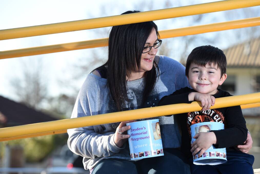 Angie Whitting, with Zayden's older brother Xavier Veal-Whitting, campaigning for the playground in 2014. 
