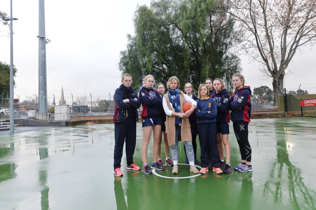 Cath Robertson with Sandhurst junior netballers, who last year highlighted the inadequacies of facilities for netballers at the QEO. Picture: DARREN HOWE