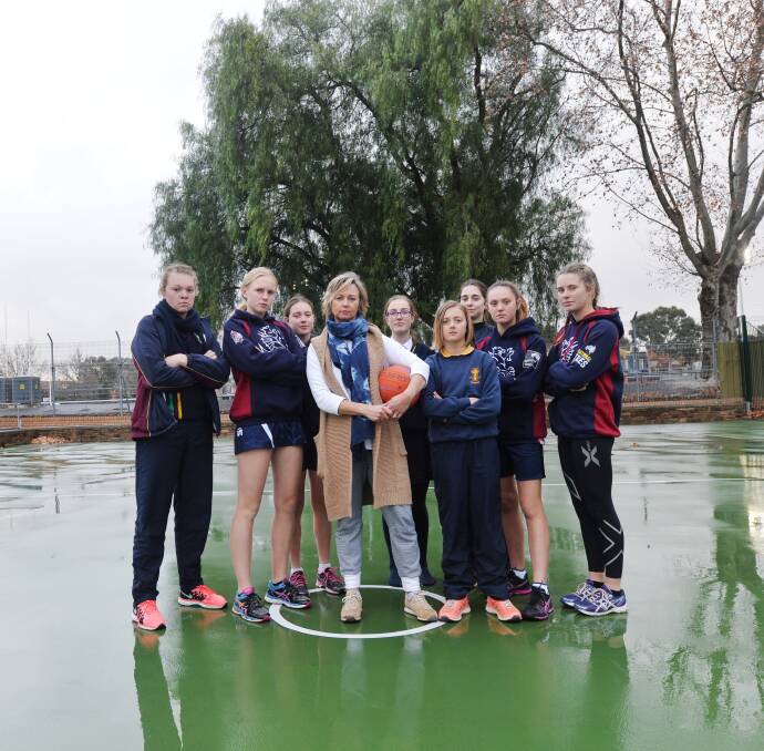 CALLS FOR CHANGE: Cath Robertson with Sandhurst junior netballers, who get changed behind trees at the QEO. Picture: DARREN HOWE