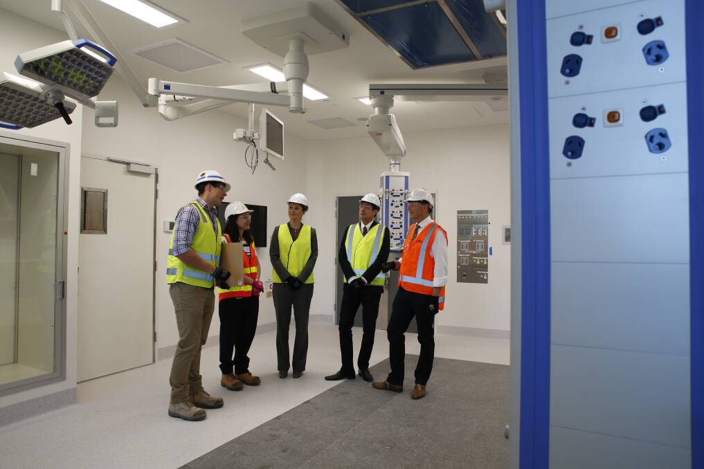 PROGRESS UPDATE: Myles McLindin of Lendlease chats to Dianne Craig, Sasha Vedelsby, Manny Cao and Bob Cameron of Bendigo Health in a new operating theatre. Picture: EMMA D'AGOSTINO