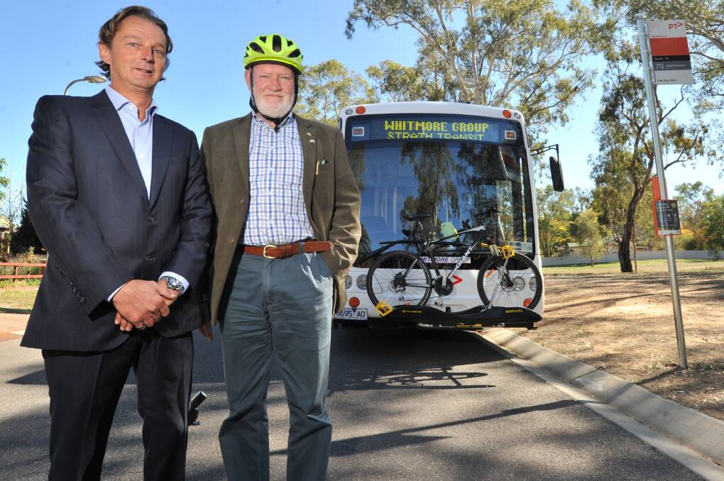 Whitmore Group managing director Jamie Whitmore and City of Greater Bendigo councillor Peter Cox celebrate the start of a Bikes on Buses trial in Strathfieldsaye. Picture: NONI HYETT