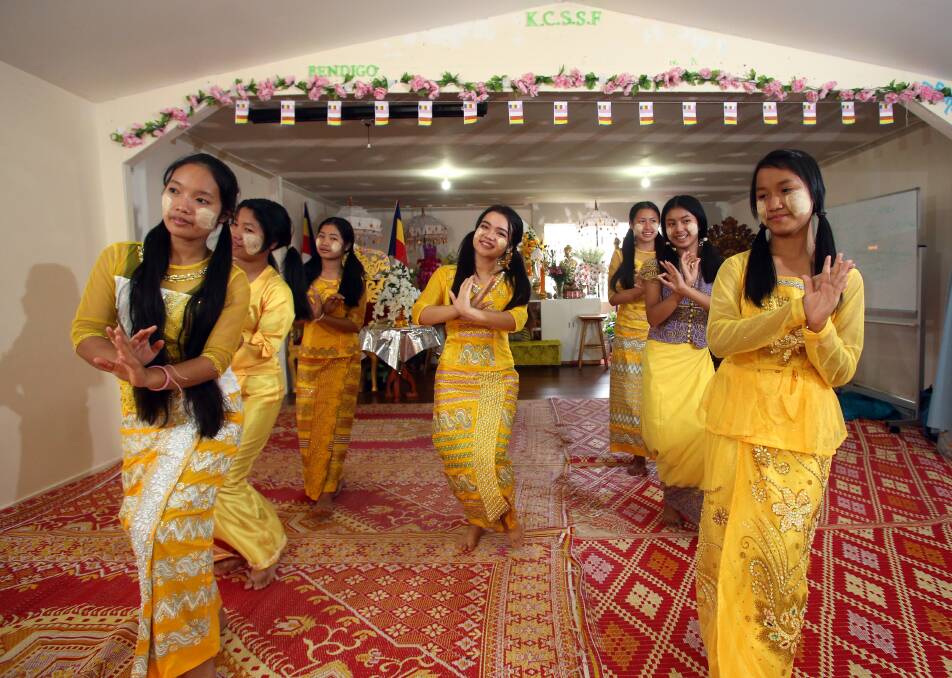 Gai Porh La Myint and fellow dancers prepare for the water festival. The colour yellow is associated with the occasion, and symbolises purity.