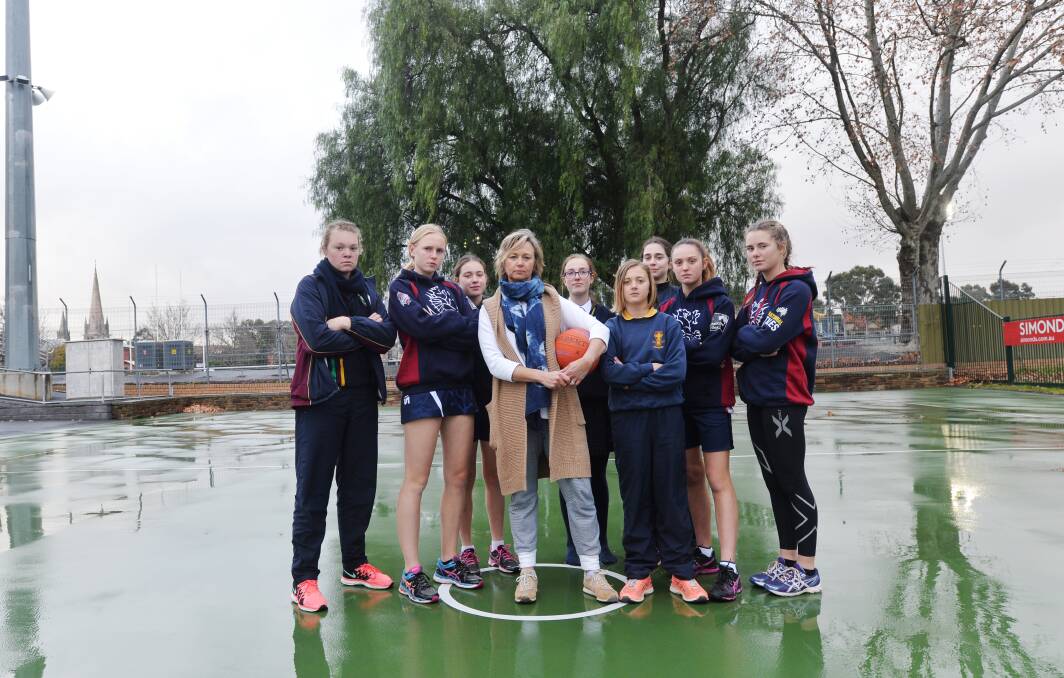 CALLS FOR CHANGE: Cath Robertson with Sandhurst junior netballers, who get changed behind trees at the QEO. Picture: DARREN HOWE