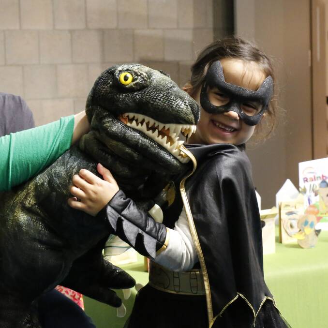Gemma Rogers, aka Batgirl, cuddles T Rex the dinosaur. Picture: EMMA D'AGOSTINO