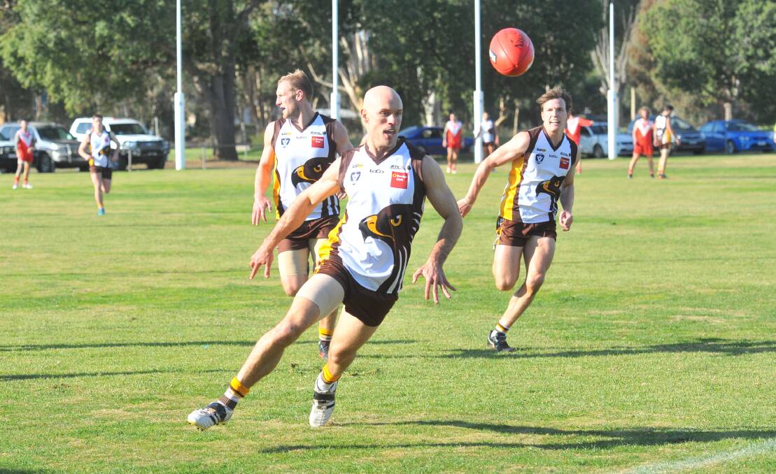 HAWKS ON THE SURGE: Huntly defender Tim Davison prepares to take possession of the ball during Saturday's 100-point win over Elmore.