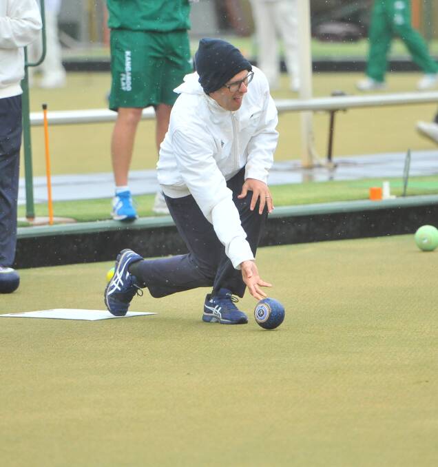 RUGGED UP: Inglewood's Craig Kelly wears a beanie to keep warm on a wet, cold and miserable day for lawn bowls on Saturday. Picture: LUKE WEST