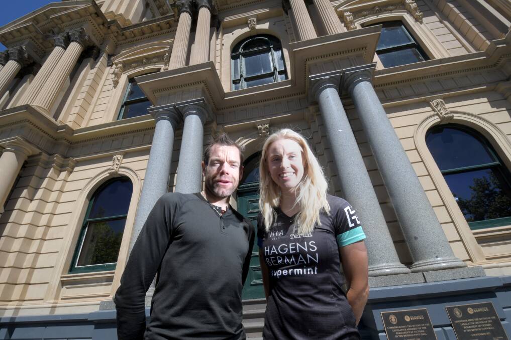 CYCLING ICON: Cadel Evans with Bendigo cyclist Peta Mullens outside the Bendigo Town Hall on Wednesday. Following a civic reception during the afternoon, Evans was the special guest at the “Keeping the Pedals Moving” event. Pictures: DARREN HOWE 