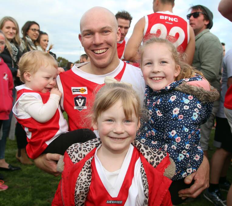 PREMIERSHIP VETERAN: Daniel Nalder with children Ellie, 16 months, Leah, 6, and Paige, 4, (front). Nalder has played in all seven flags during the dynasty.