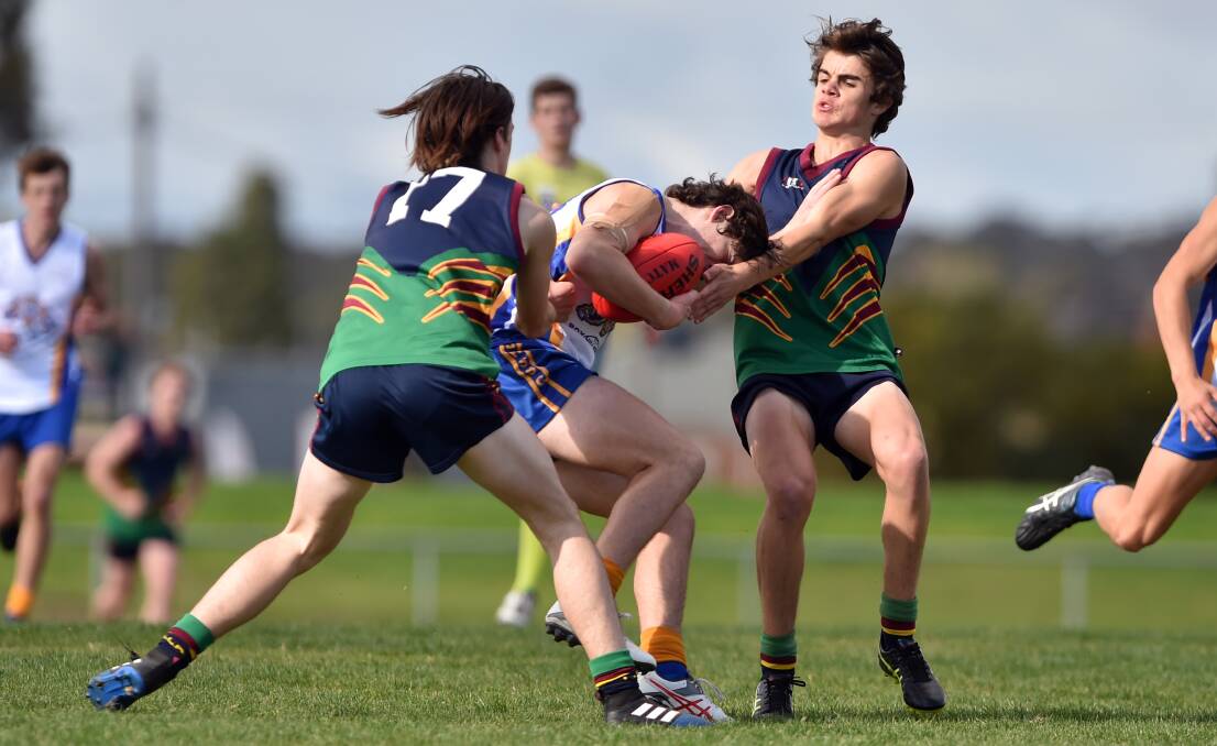 HEAT IS ON: Catholic College Bendigo applied plenty of pressure to Box Hill Secondary College. CCB won Wednesday's football match by 54 points at Epsom-Huntly Recreation Reserve. Picture: GLENN DANIELS