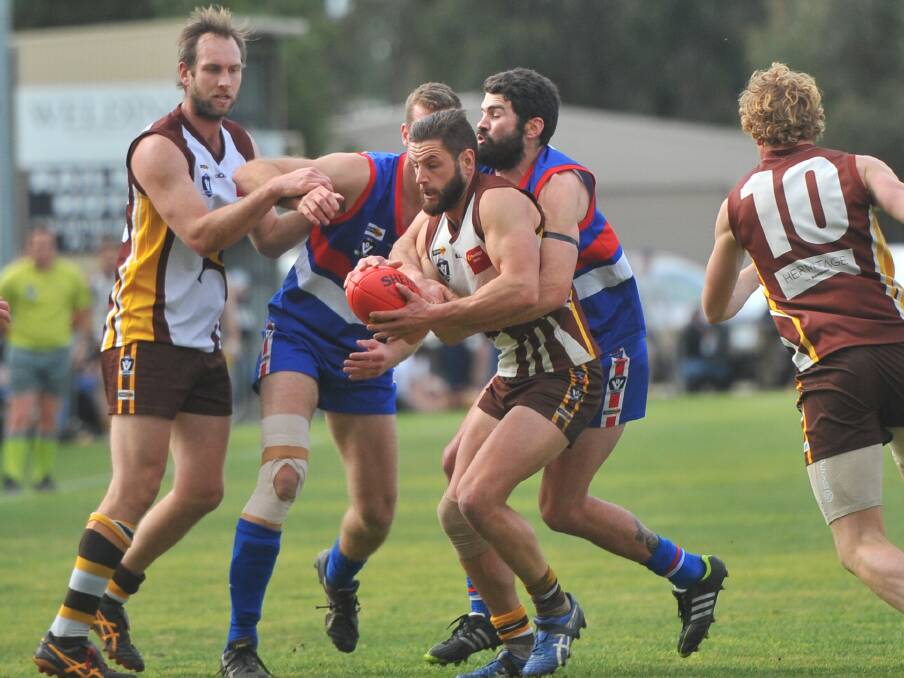 TACKLE: North Bendigo's Alex Shipard wraps up Huntly star Ryan Semmel. Shipard wore Semmel like a glove all game and was one of the Bulldogs' best.