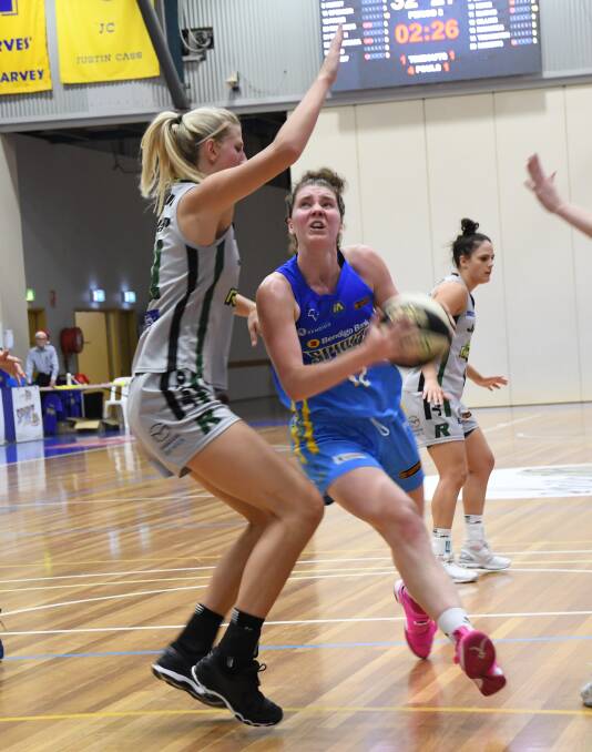 DRIVE: Bendigo's Spirit's Nadeen Payne, who is defended by Dandenong's Carley Mijovic, attacks the basket. Payne scored 16 points. Pictures: LUKE WEST